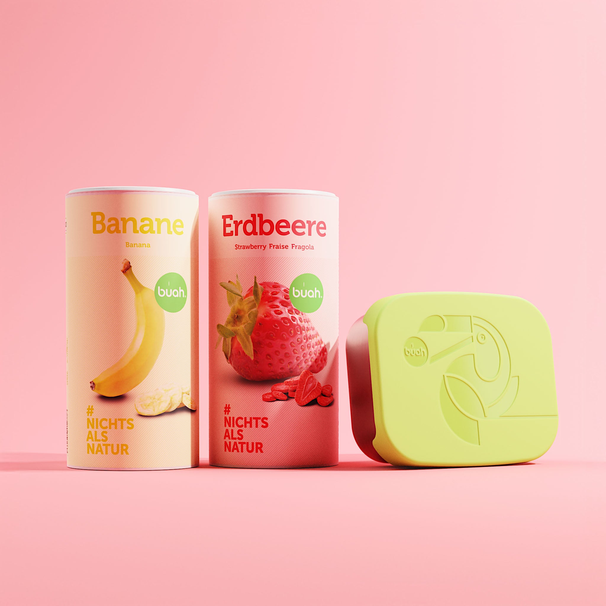 buah Aktions-Set mit einer Dose buah Banane und Erdbeere nebeneinander stehend, daneben buah Lunchbox aus Edelstahl mit gruenem Deckel aus Silikoon